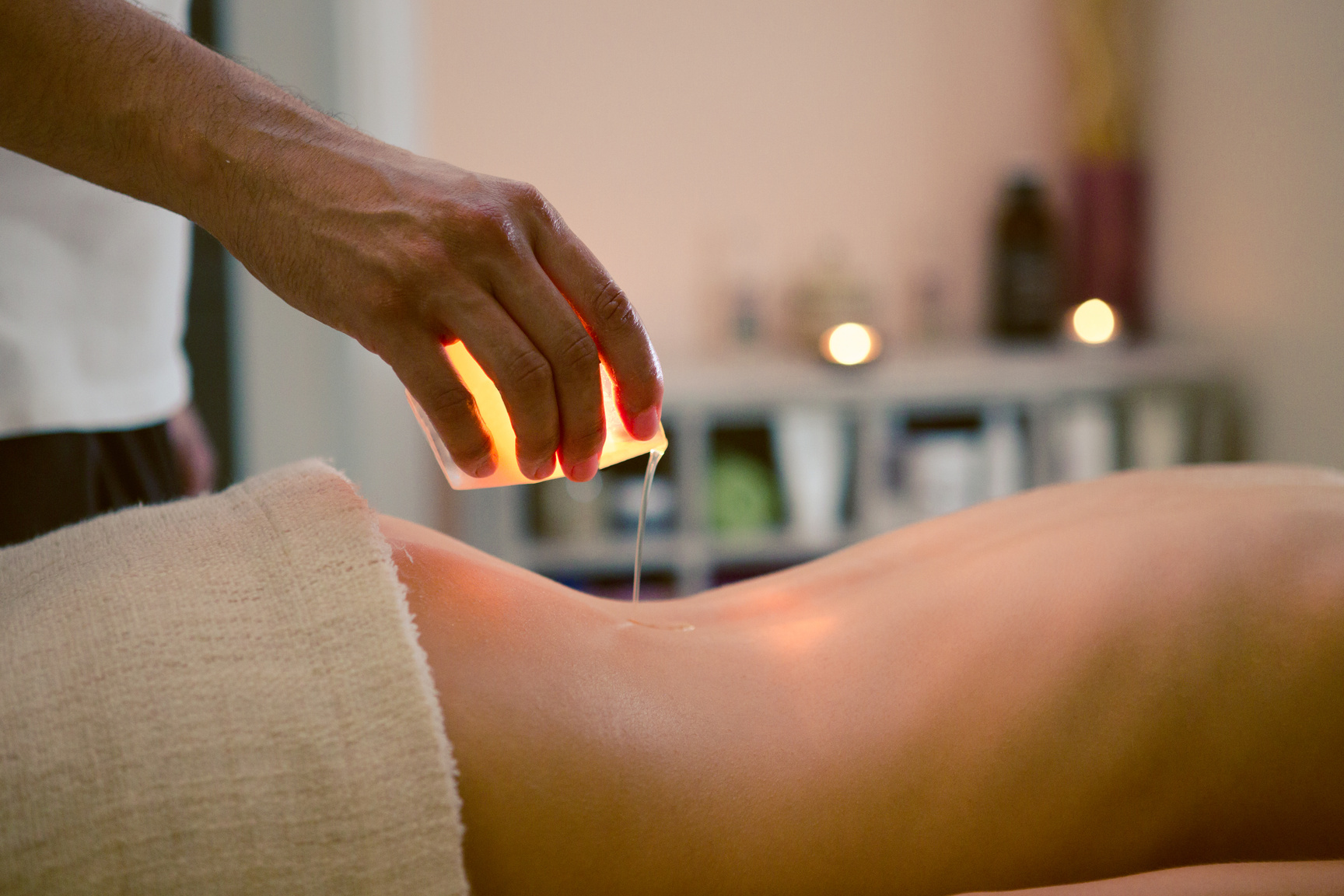 Woman getting massage with a candle